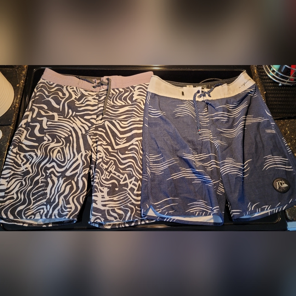 Two Pairs Of Quiksilver Kids Swim Trunks - Black & White/ Blue & White Patterns